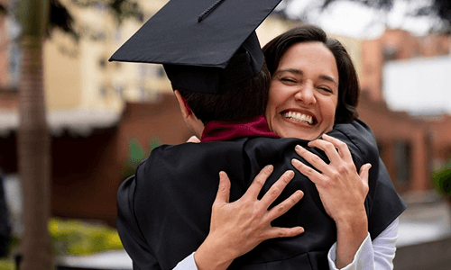 Madre abrazando a su hijo recién graduado.